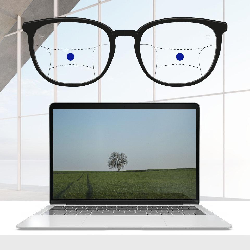 Una montura con lentes progresivos y líneas esquemáticas para indicar las distintas zonas de visión. Se destacan diferentes partes del lente: intermedia - parte central de los lentes.